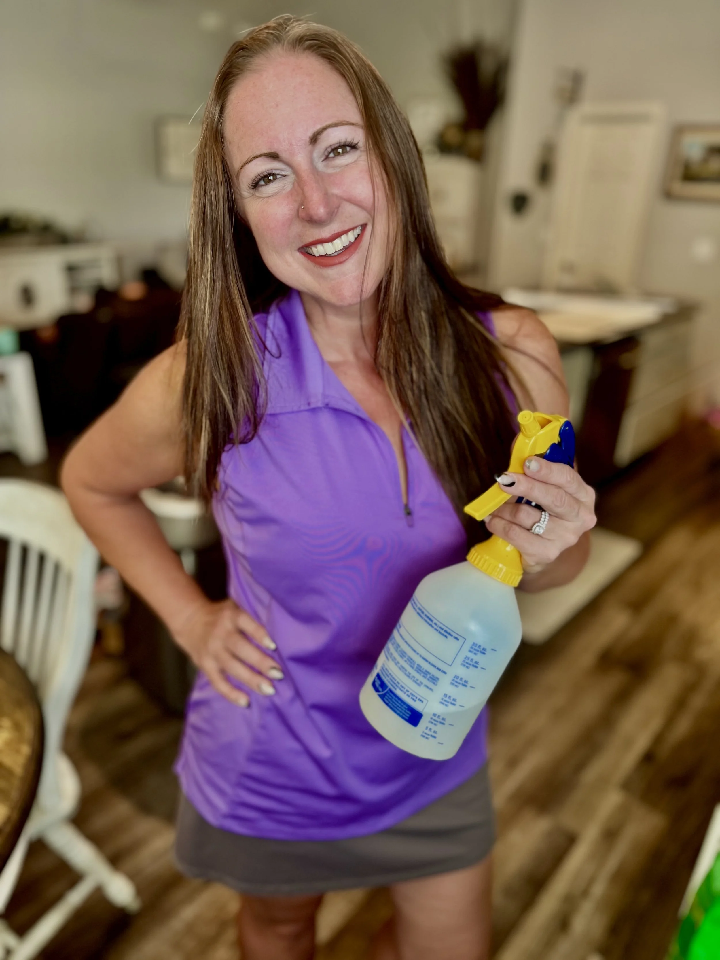 Robin Ford, Owner at Delightfully Clean, Holding Spray bottle