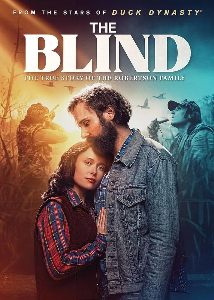 Movie poster for 'The Blind: The True Story of the Robertson Family,' showing a man with a beard and a woman with dark hair close together in the foreground, with a background of people hunting in the woods.