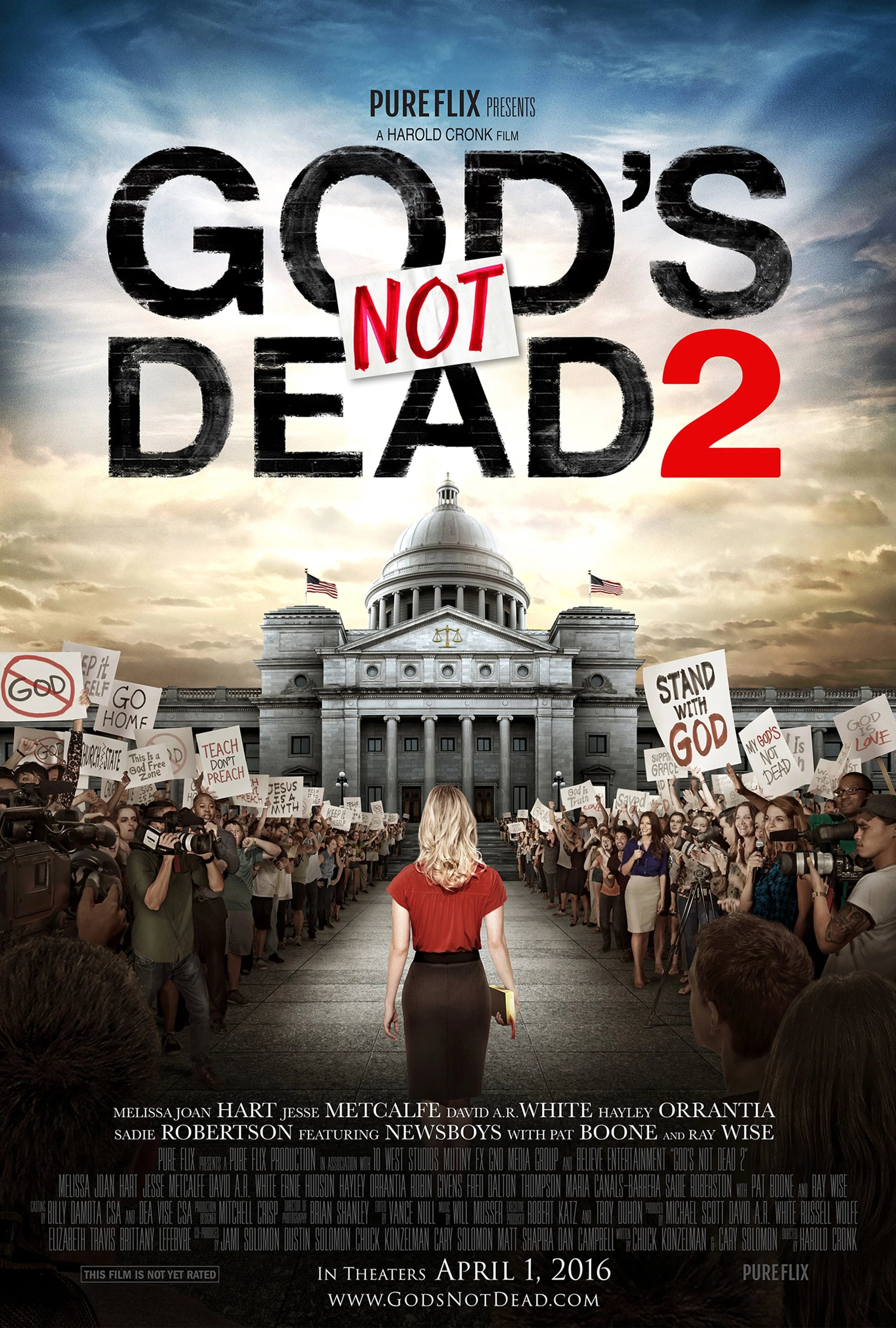 Movie poster for "God's Not Dead 2" showing a woman walking towards the Capitol building with protestors holding signs, with the title "God's Not Dead 2" and release date April 1, 2016.