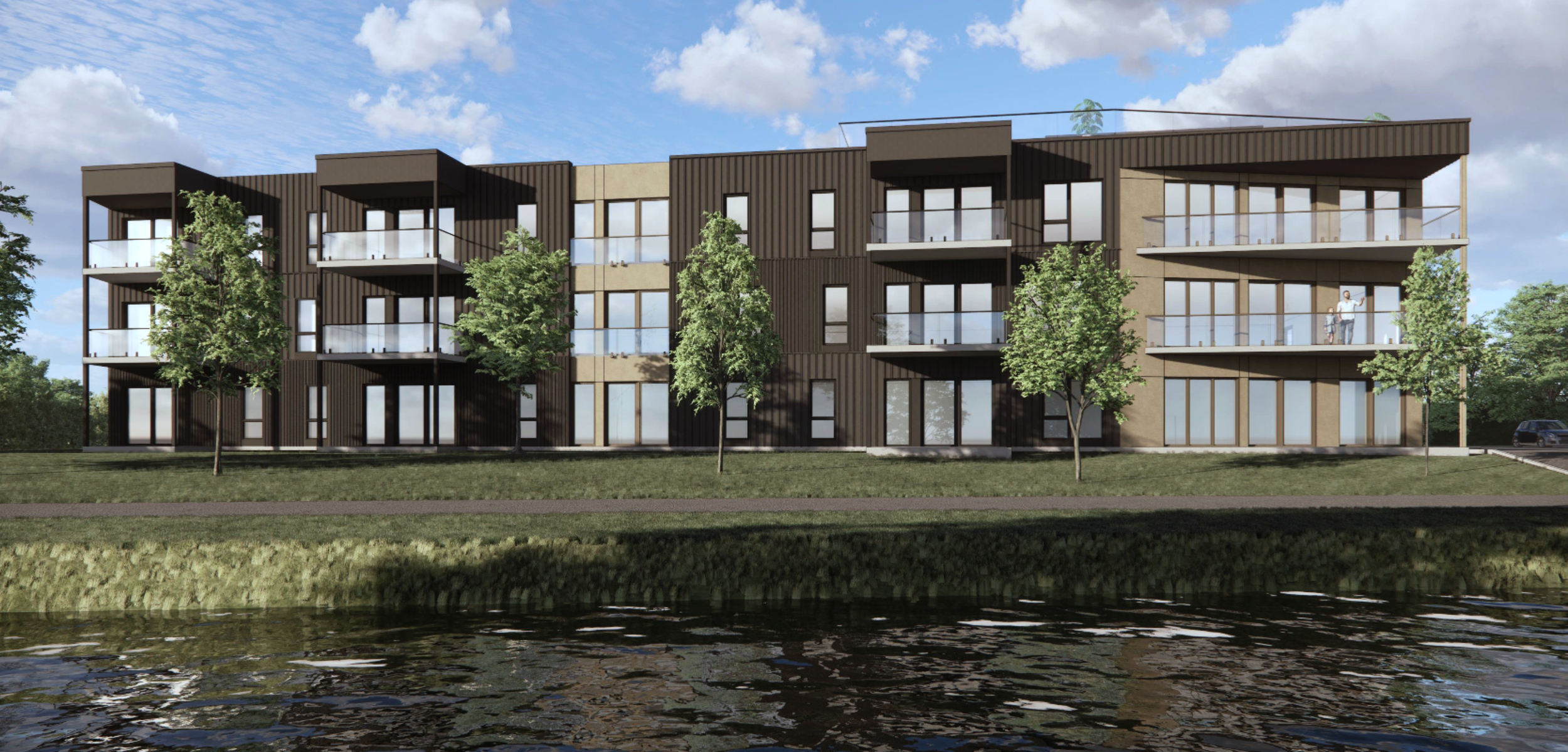 Impression 3D de la façade de l’immeuble Le Rivage à Magog, avec plusieurs étages, balcons, grande fenêtres et arbres dans un espace vert, situé près de la rivière Magog.