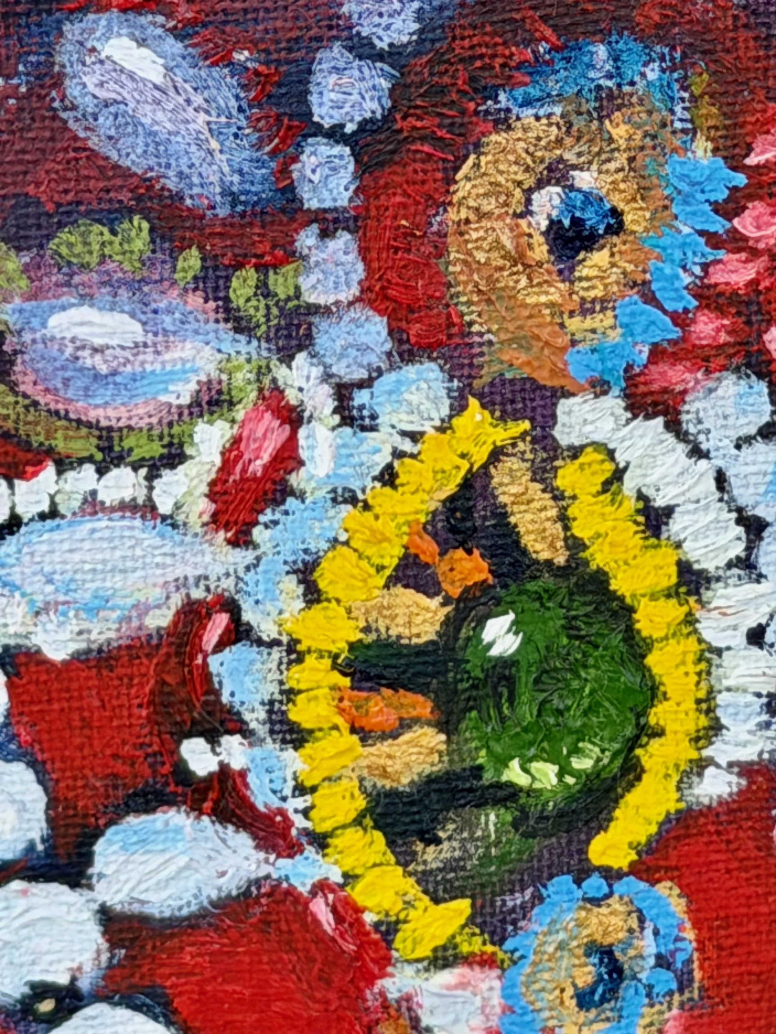 Close-up of a colorful, textured abstract painting with vibrant colors including red, yellow, blue, green, white, black, and purple.