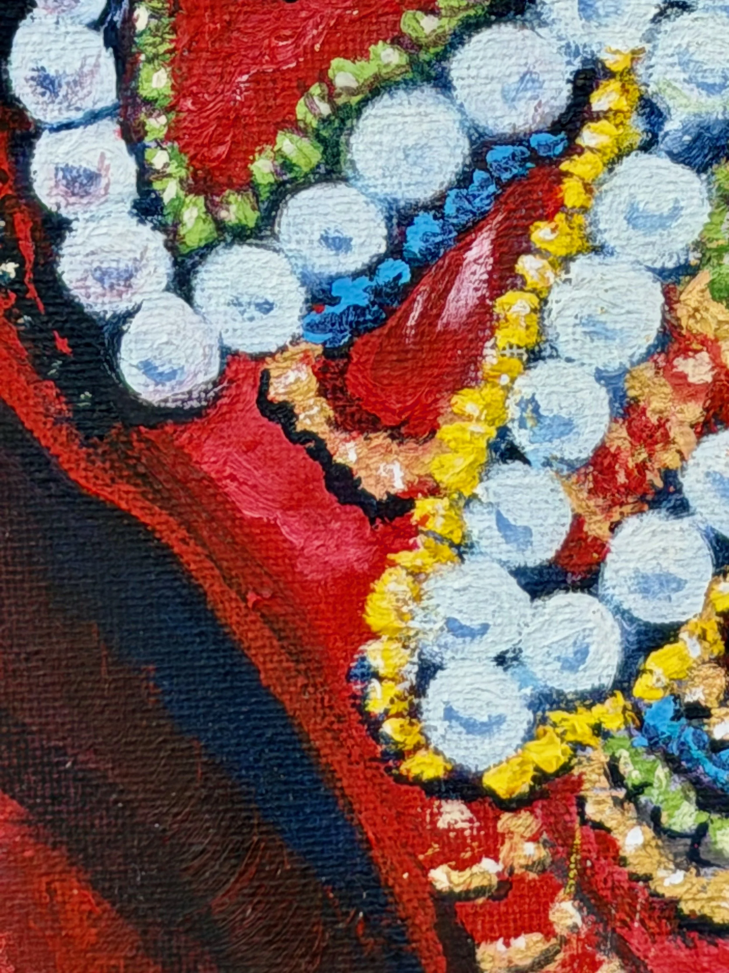 Close-up of a vibrant, abstract painting featuring colorful beads and similar decorative elements on a textured canvas.