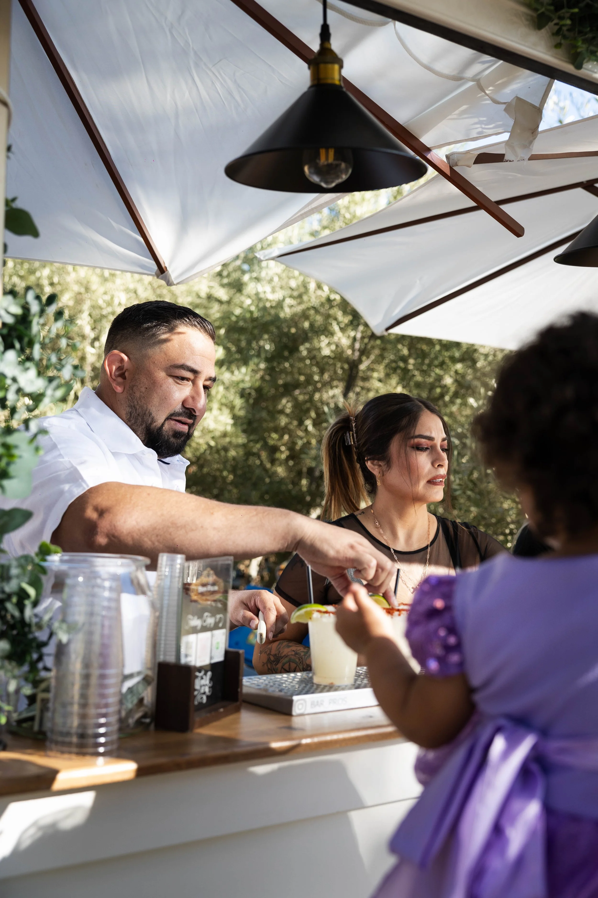 Bartender serving beverages from a cart at a quinceañera at Monarca Ranch Hemet CA