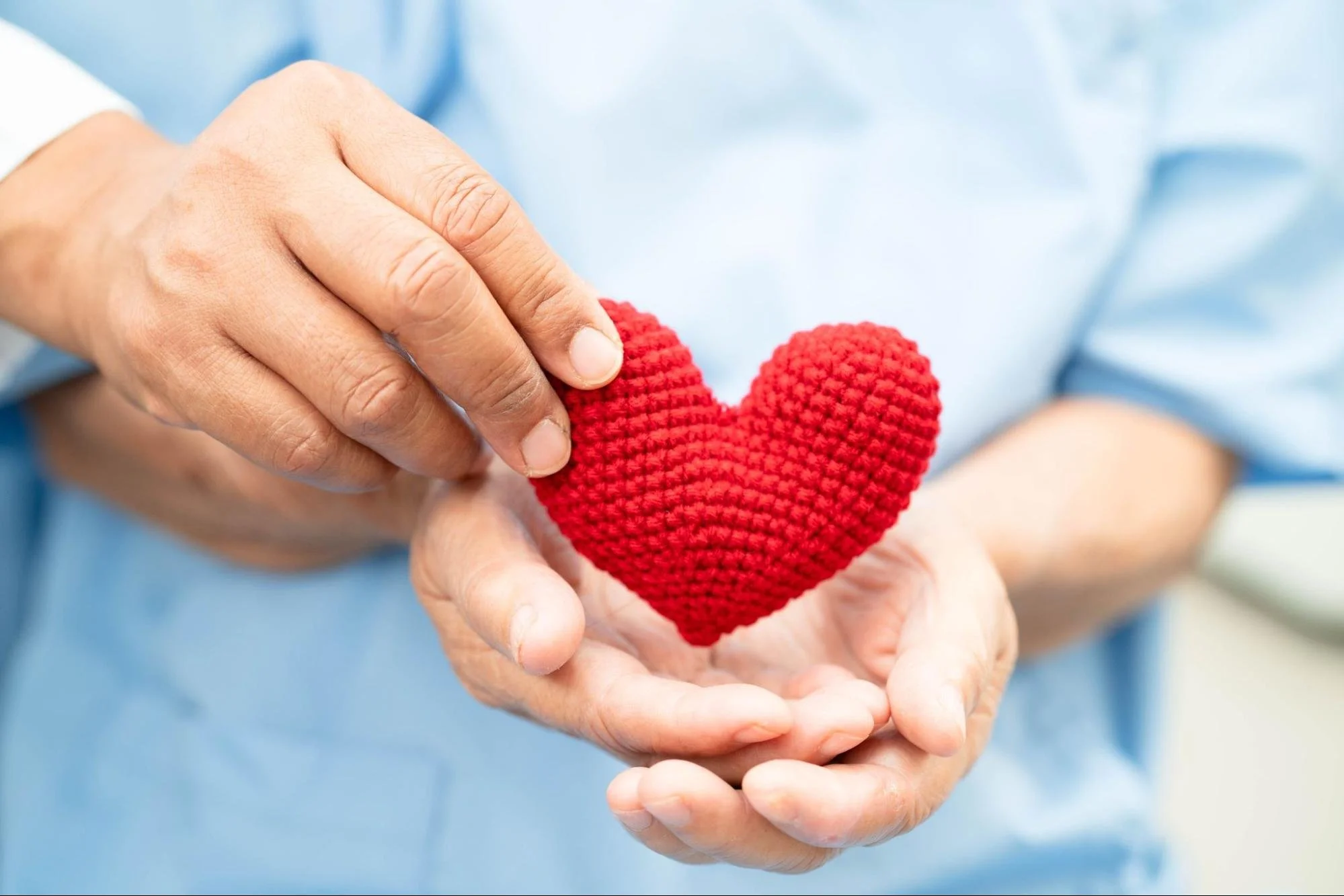 Person holding a red heart to represent heart health, longevity, and preventive care- HealthSpan Internal Medicine in Boulder CO