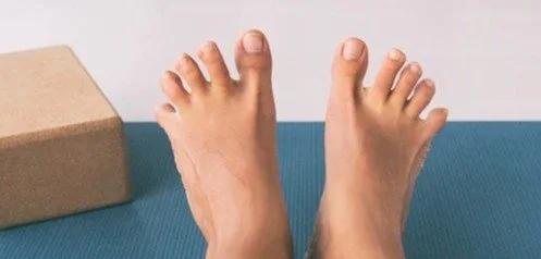 Person stretching toes on a mat for blog about how does gait reflect brain health and what does your walking pattern reveal about your cognitive health. Image used by Dr. Jessica Knape of HealthSpan Internal Medicine in Boulder, CO.jpg