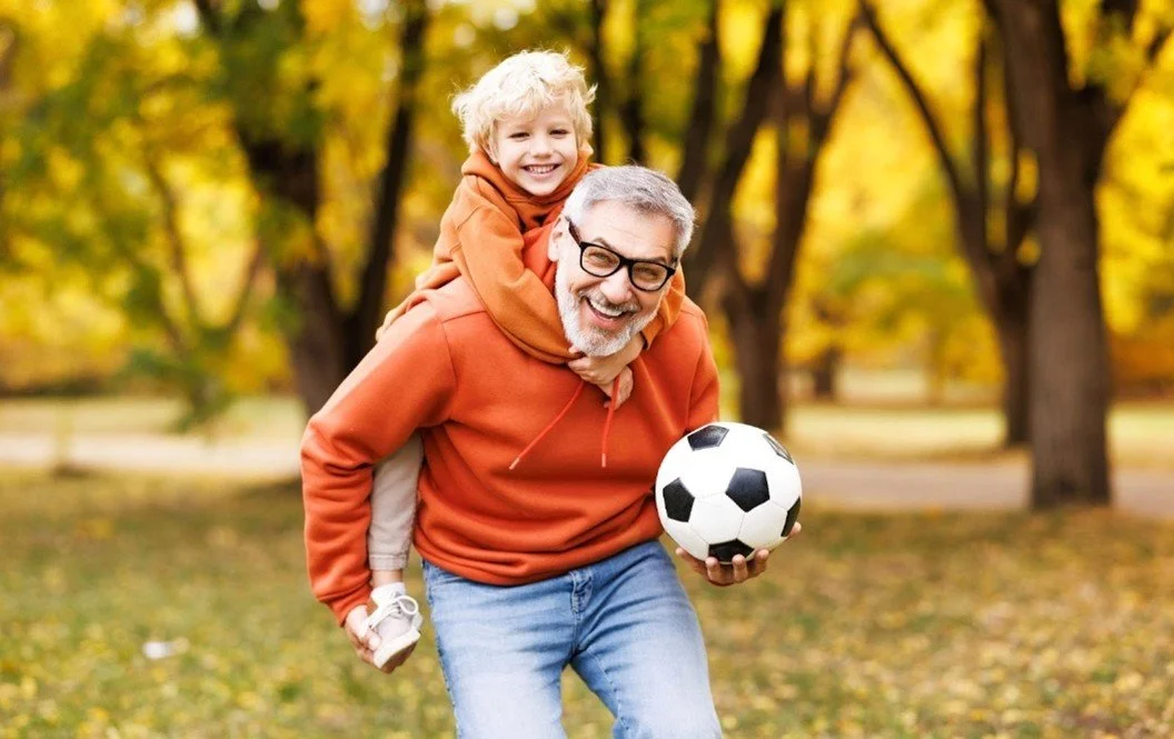 Elder man happily playing with his grandson for blog about best way to improve balance and prevent falls naturally. Image used by Dr. Jessica Knape of HealthSpan Internal Medicine in Boulder, CO.jpg