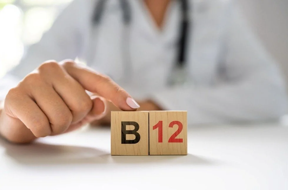 Doctor finger pointing a b12 wooden cubes for blog about why are most older adults with b12 deficiency and how it affects the brain. Image used by Dr. Jessica Knape of HealthSpan Internal Medicine in Boulder, CO.jpg