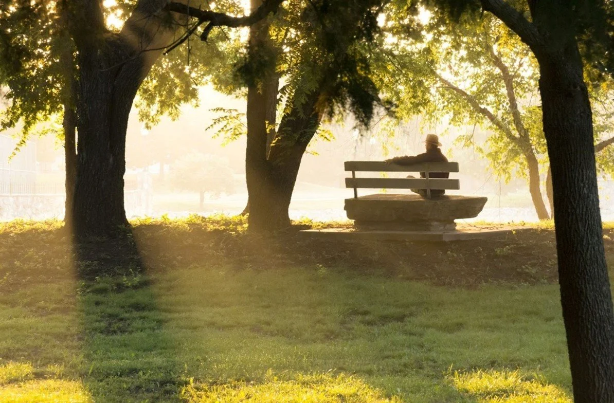 A person sitting alone on a bench in a park for blog about why is isolation a killer by Image used by Dr. Jessica Knape of HealthSpan Internal Medicine in Boulder, CO.jpg