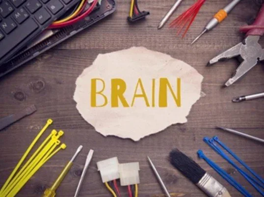 Tools around brain written in paper demonstrating the complexity of fixing the brainImage used by Dr. Jessica Knape of HealthSpan Internal Medicine in Boulder, CO.