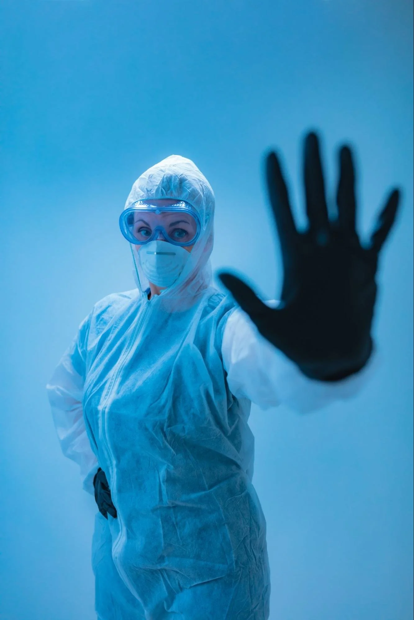 Dr with protective uniform and gloves showing a high-five-for-blog-about-what-are-five-signs-of-dementia-by-dr-jessica-knape-healthspan-internal-medicine-in-boulder-co
