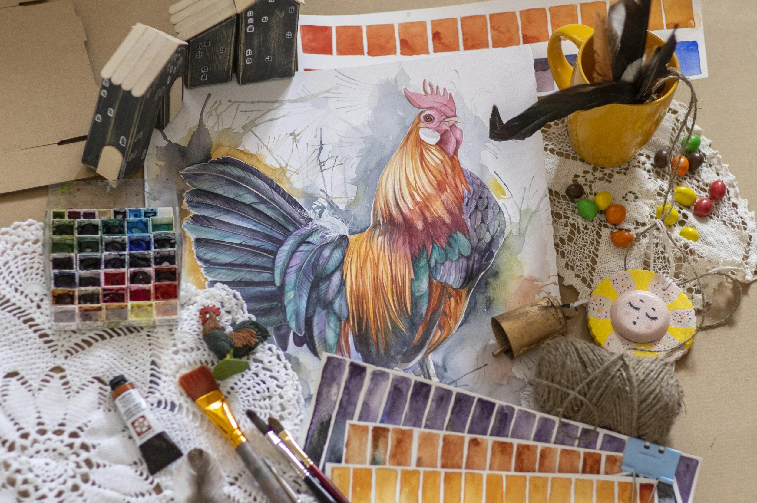Painting of a rooster with art supplies