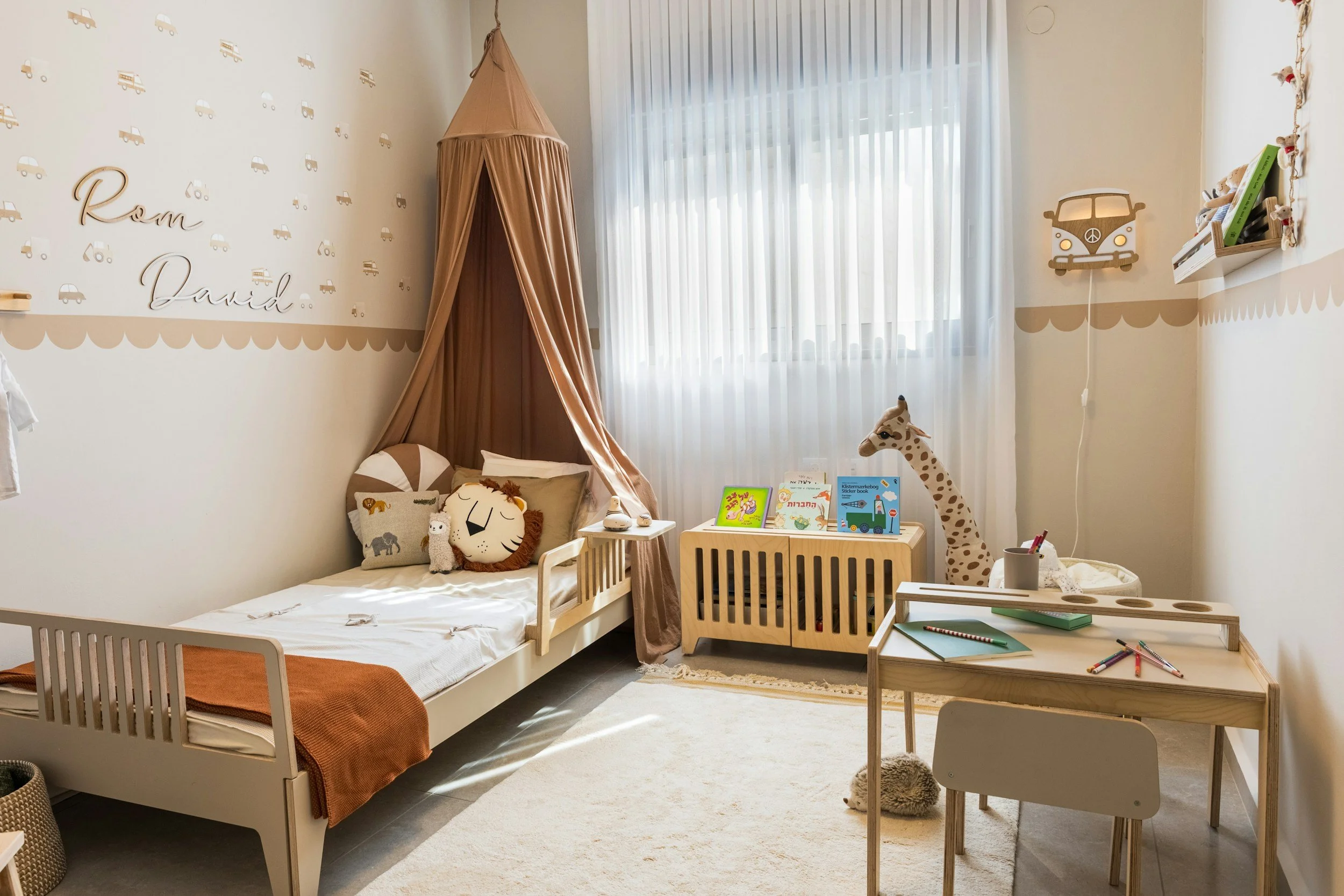 Childhood bedroom with a canopy bed and craft table