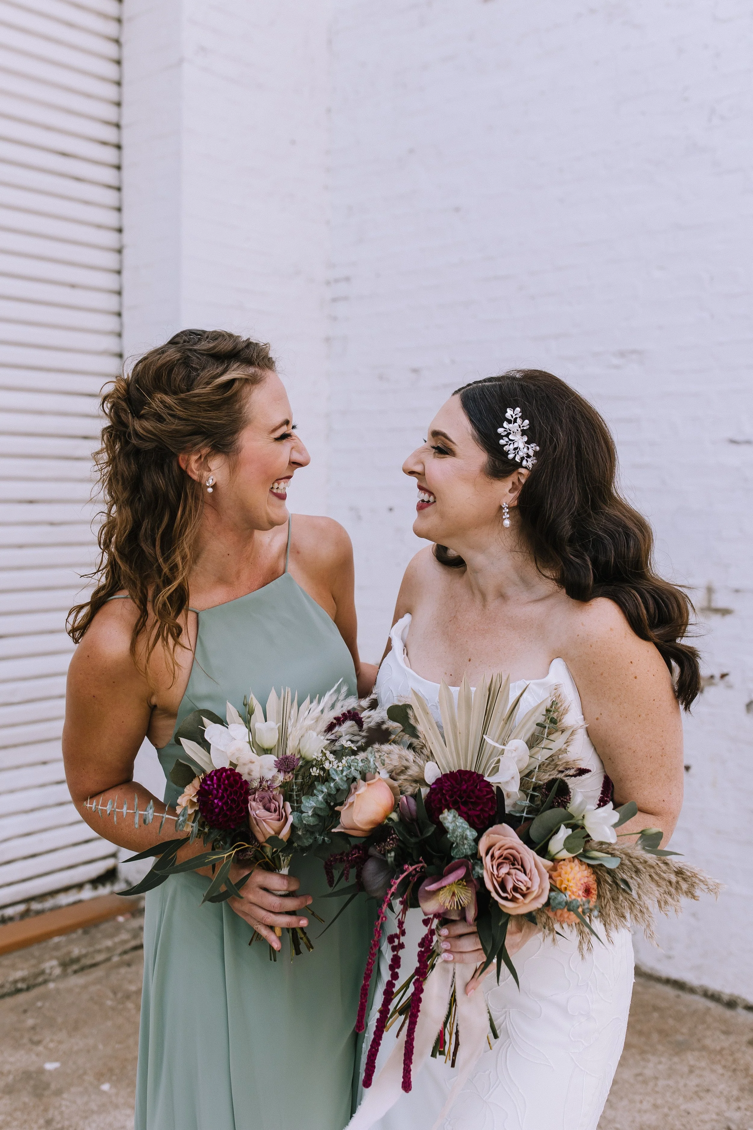 Bride with bridesmaid holding bouquets