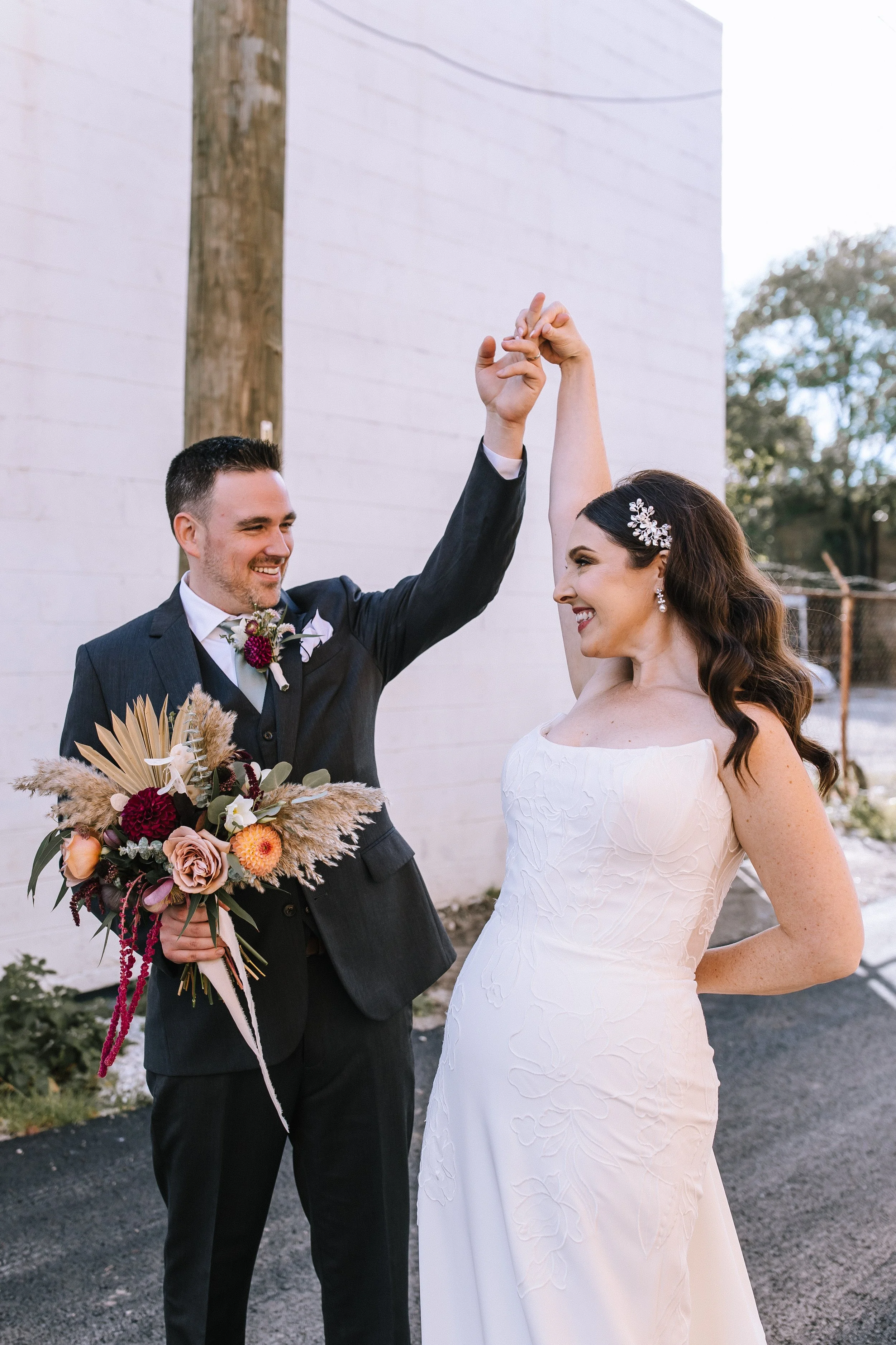 Bride and groom smiling and dancing