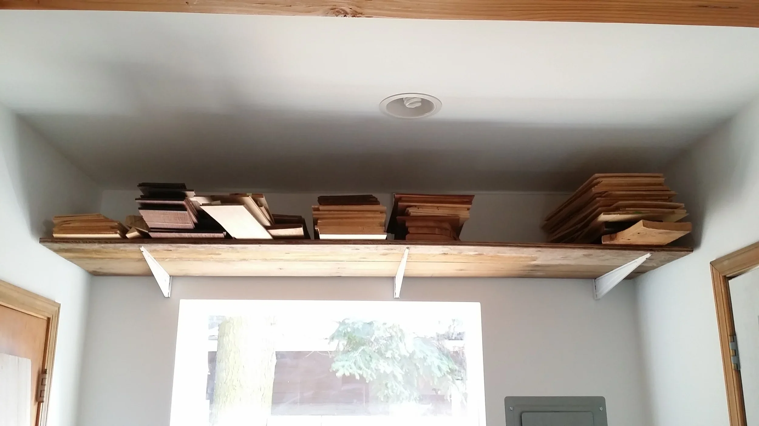 Tonewood stacked on a shelf in a luthier shop