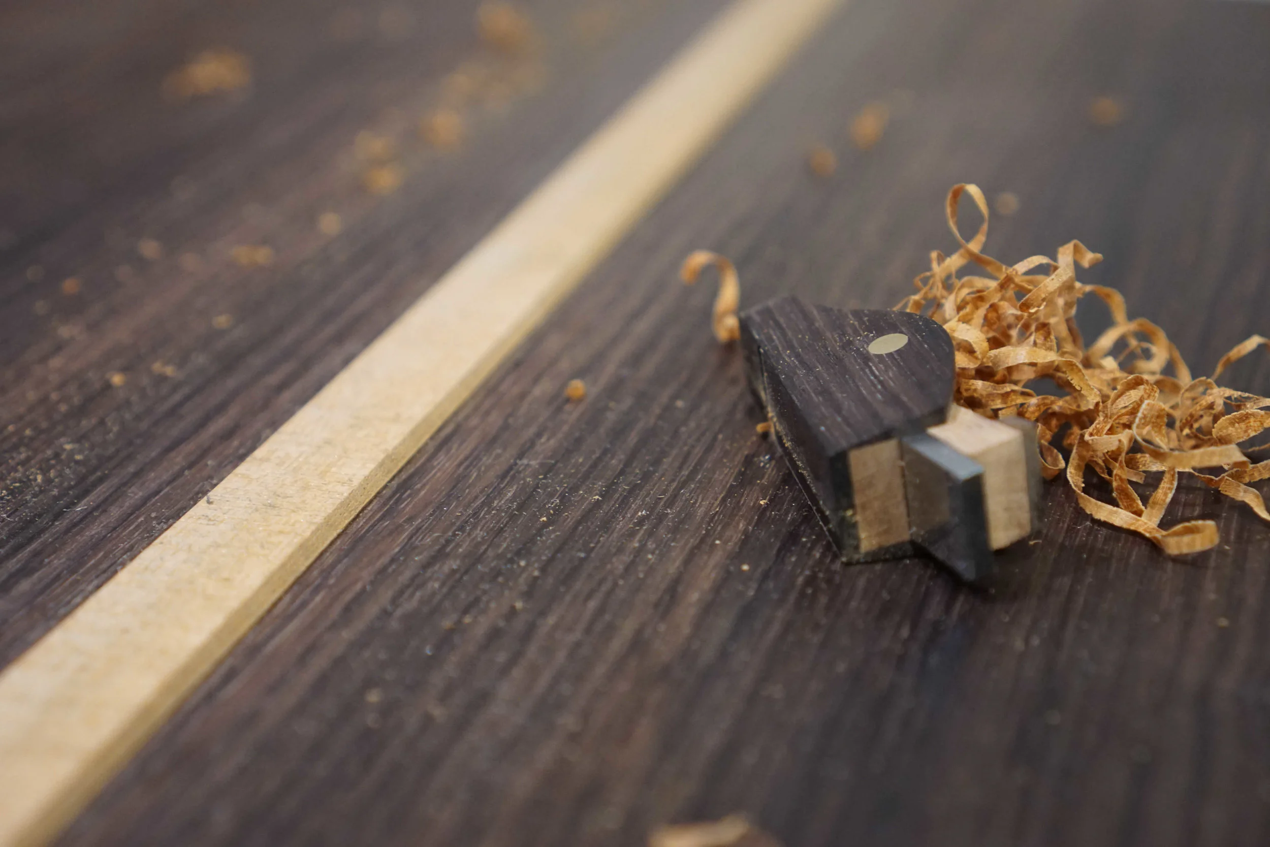 Small wood plane and center strip of guitar