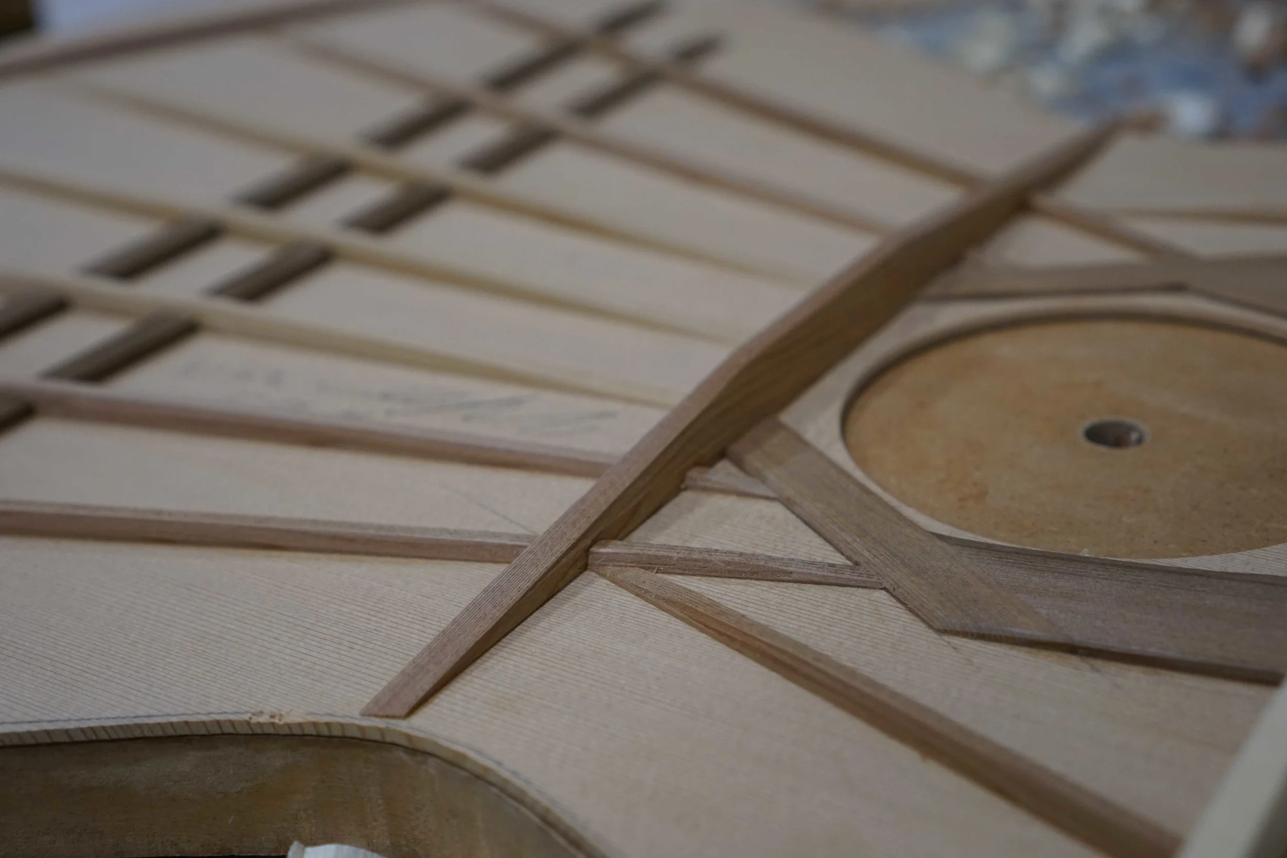 The underside of a classical guitar top showing the bracing.