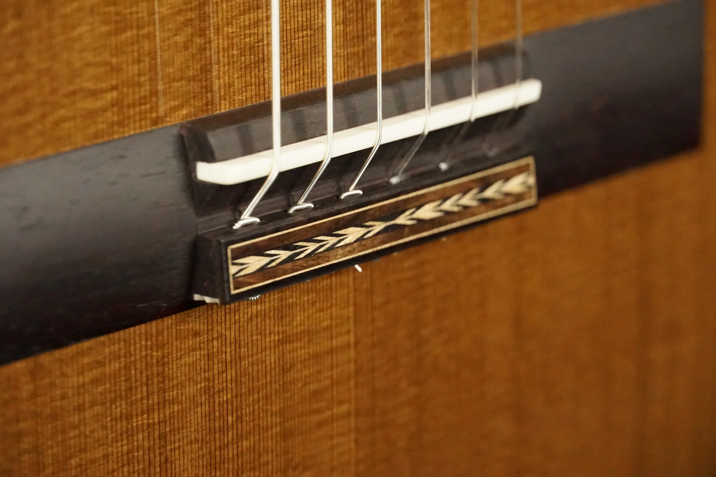 Classical handmade guitar bridge with inlay.