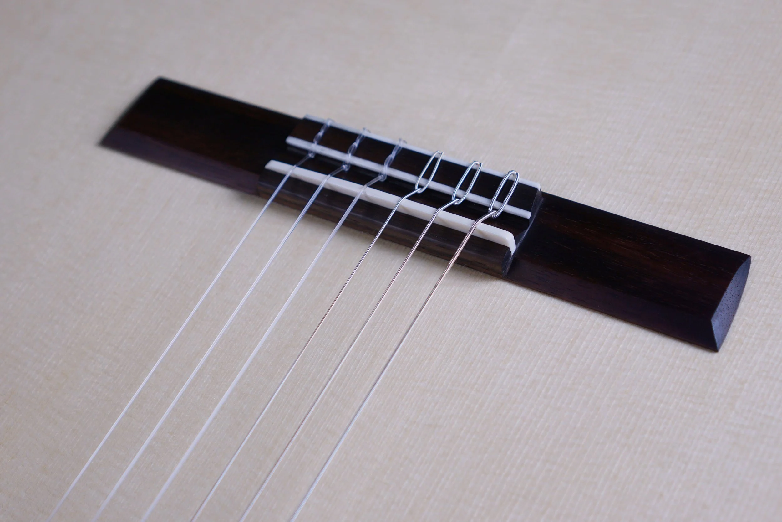 close up of classical guitar bridge.jpeg