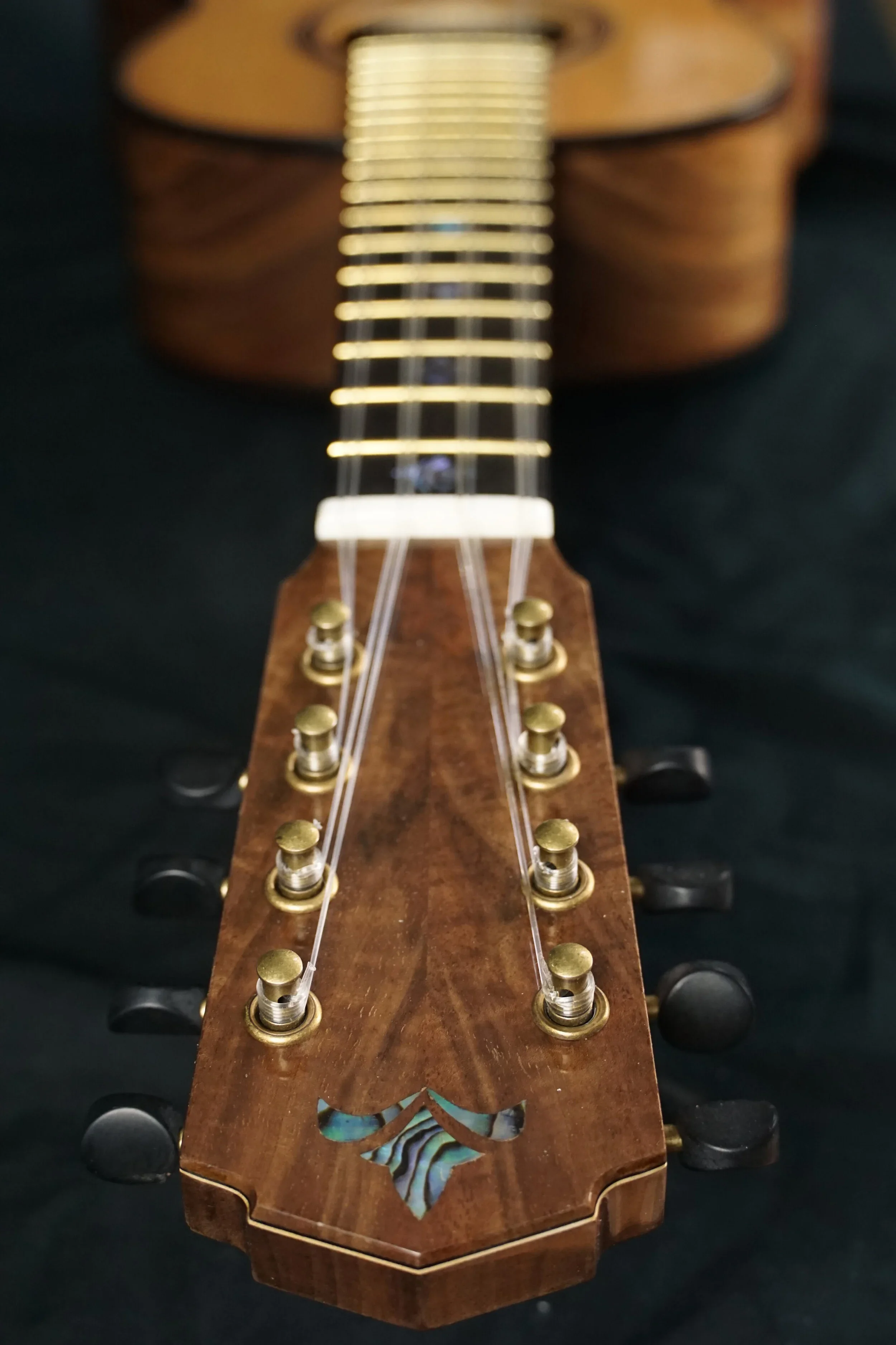 eight string uke head stock from top.webp