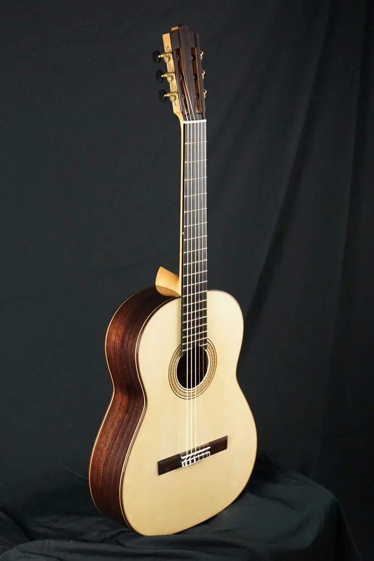 Classical Guitar East Indian rosewood / Swiss spruce 650mm scale on black background.