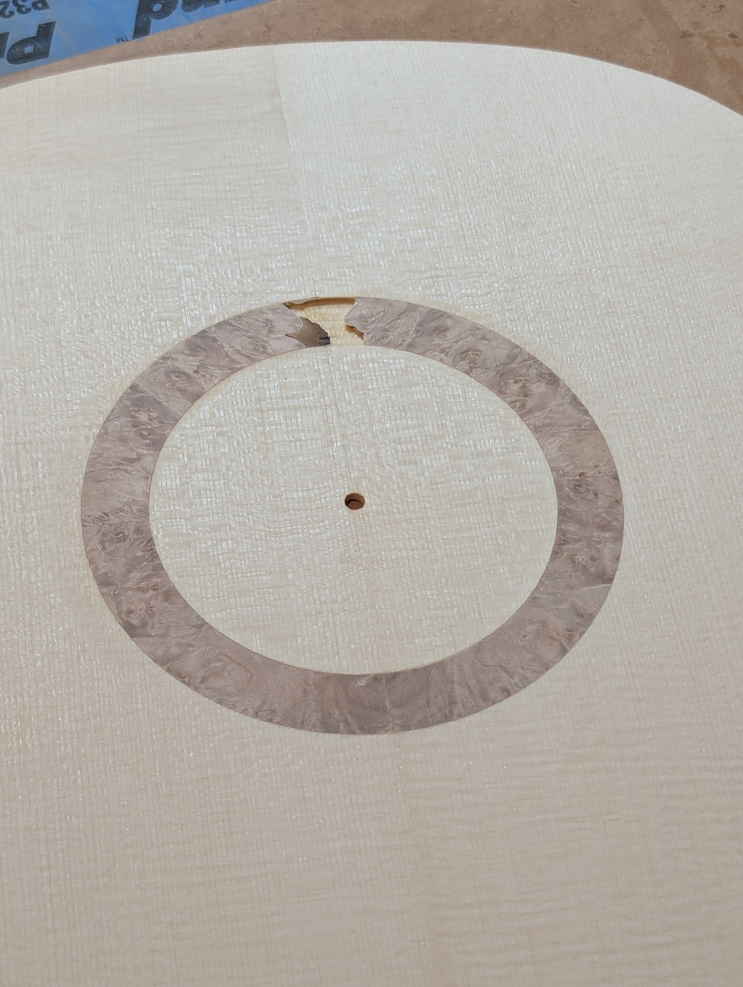 Burl inlay during the construction of classical guitar, unfinished ready for the sound hole to be cut out.