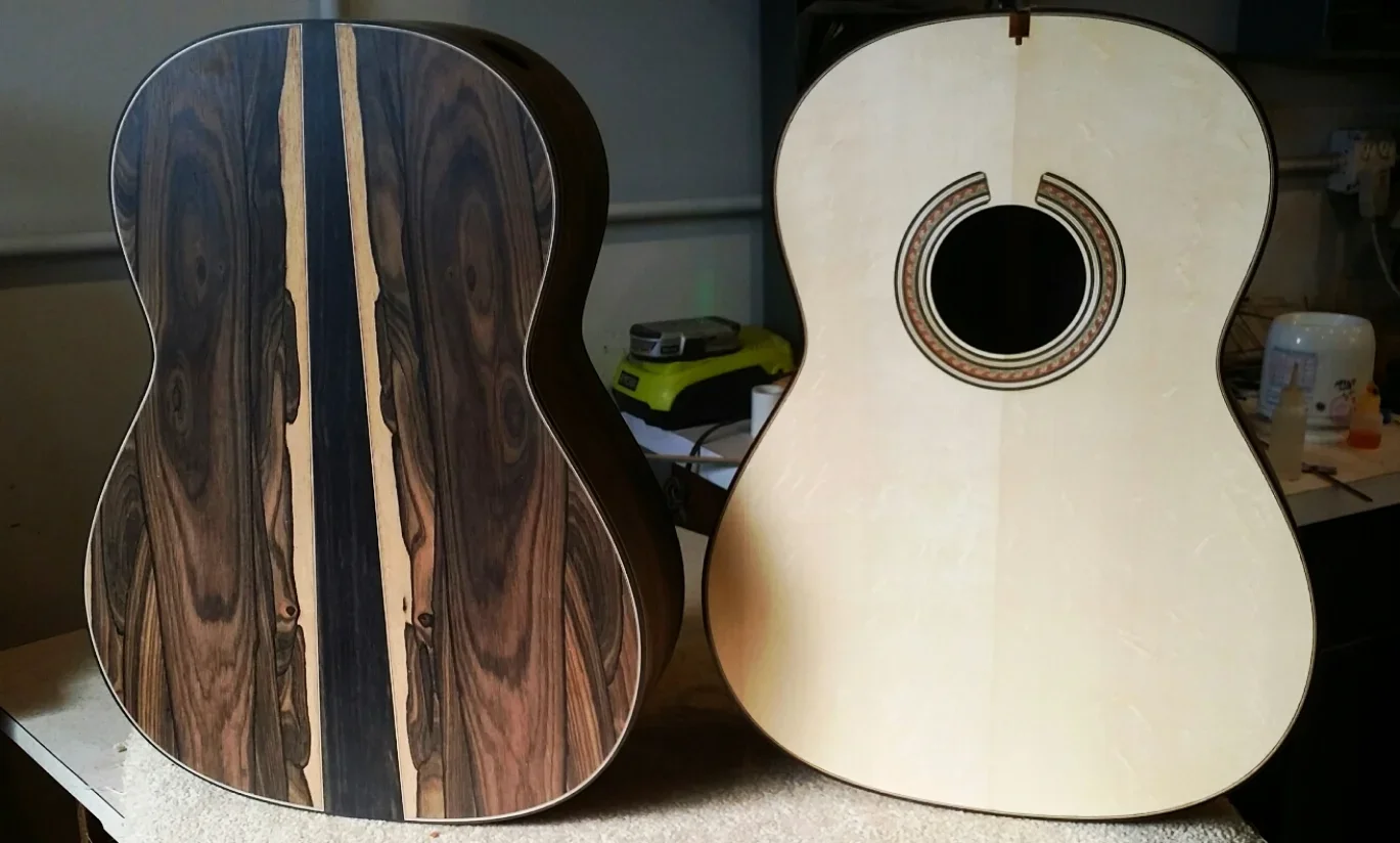 Two guitar bodies in progress sitting on a workbench.