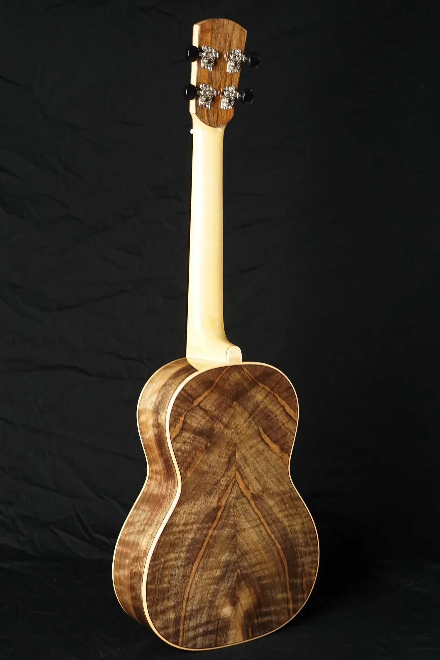 Back of a walnut ukulele with a spruce neck.