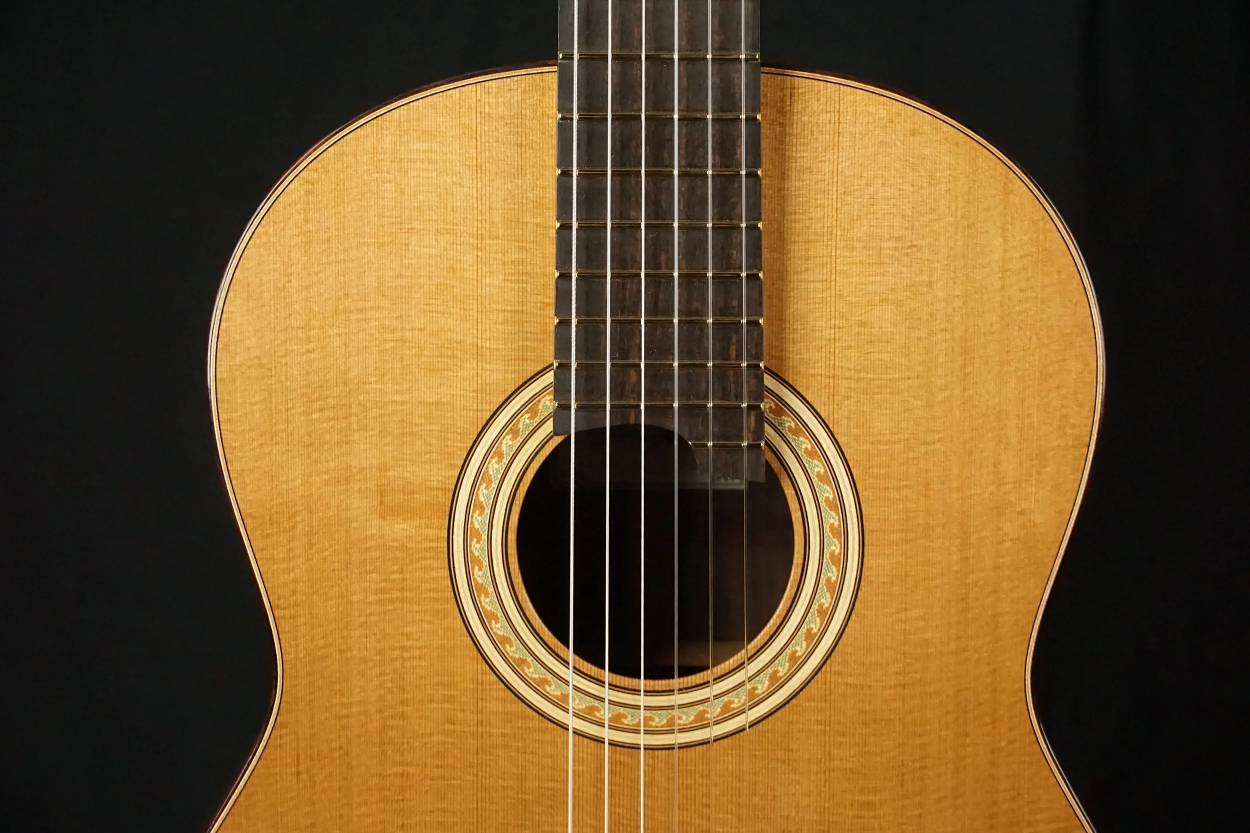 Cedar top classical guitar with black background