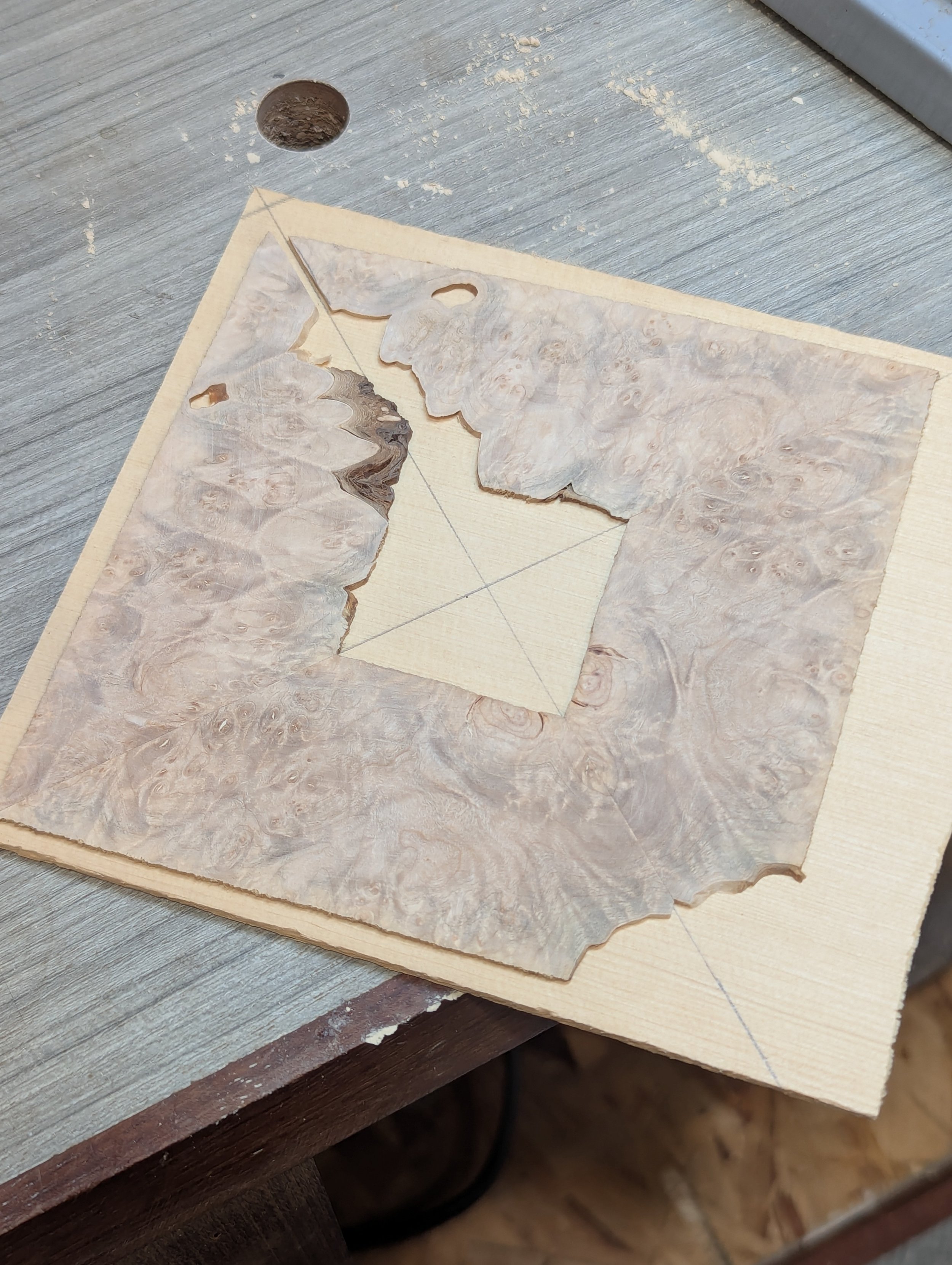 A piece of burl wood from which a guitar rosette will be cut out 