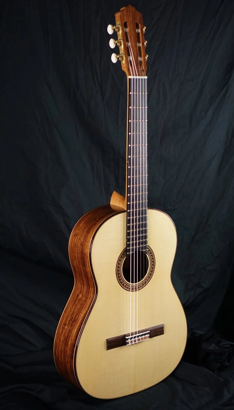 Classical Guitar in Honduran Rosewood photographed on a black background.
