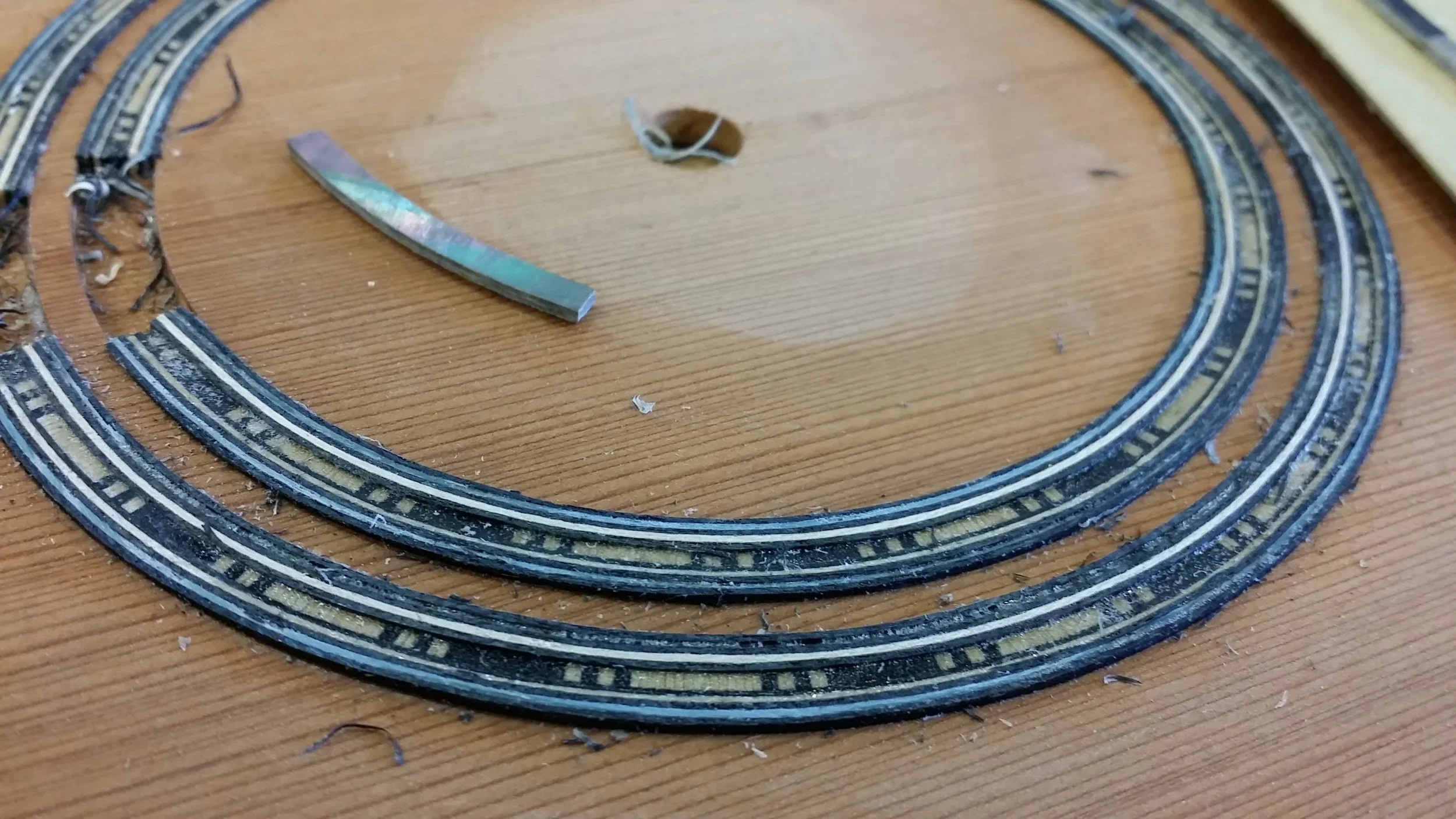 Setting in a guitar rosette with Tahitian black mother of pearl.