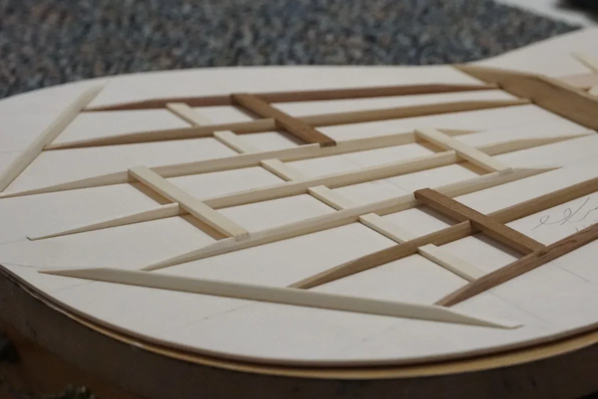 “floating tie” type guitar bracing on a spruce top.