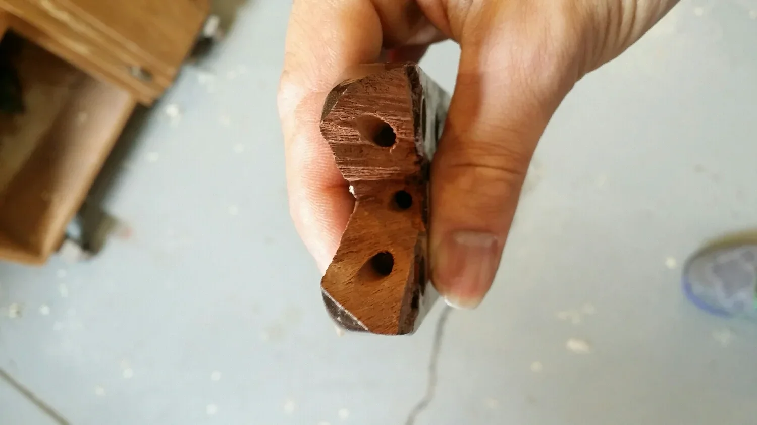 Three holes for carbon fiber rod in a Martin headstock.
