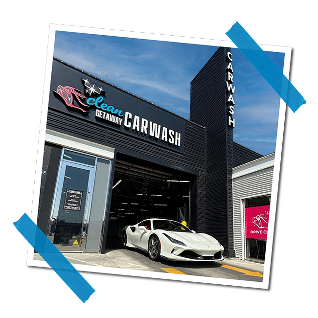 Image of an exterior car wash facility named 'Clean Getaway Car Wash' with a luxury white sports car parked outside.
