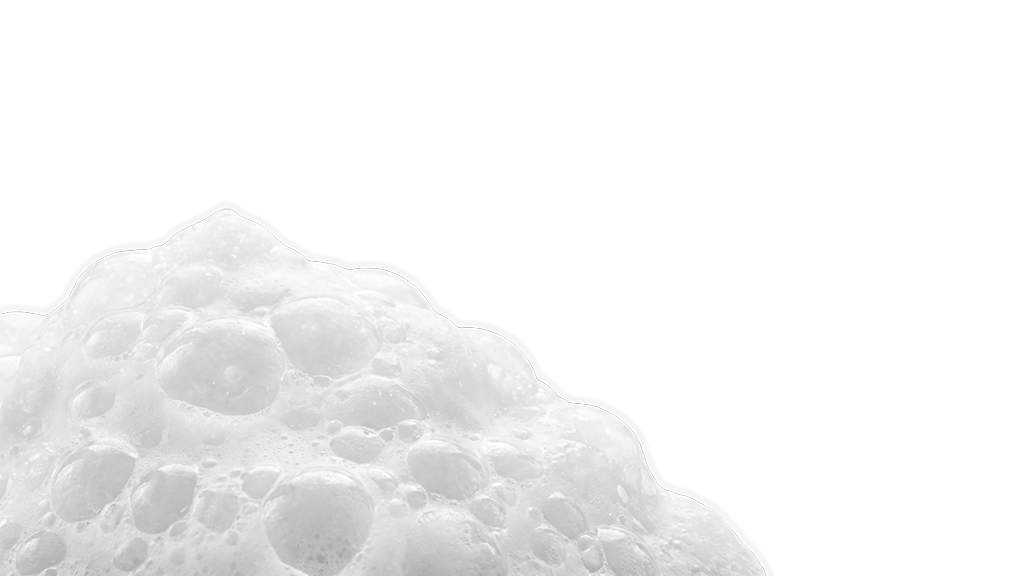 Close-up of a frothy, foamy white substance, likely soap or foam, against a black background.