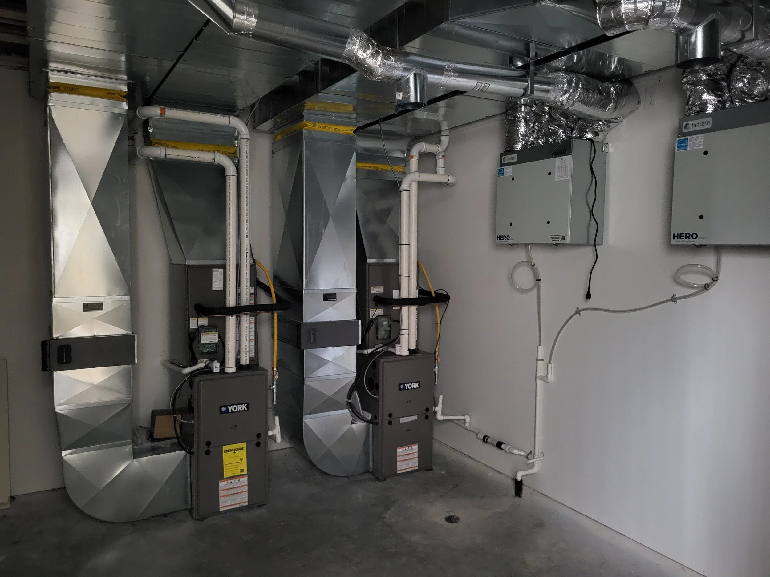 HVAC system with metal ducts, fans, and electrical units in a utility room, Nova Scotia installed by red seal certified professionals. providing clean air quality. furnace and HRV