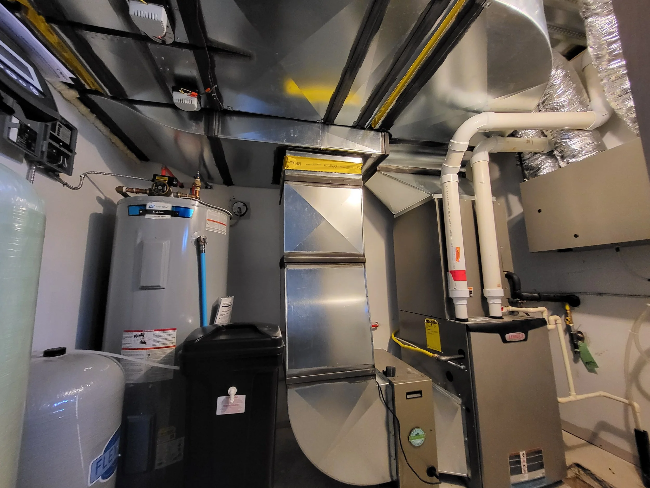A utility room in home with water heater, HVAC system, and various pipes and ducts.  furnace, custom ventilation, Halifax Nova Scotia