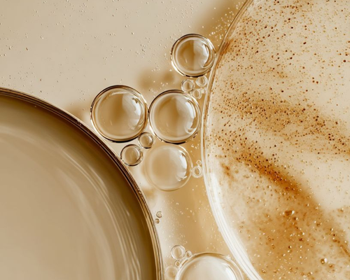 Close-up of coffee and cream with bubbles and frothy surface