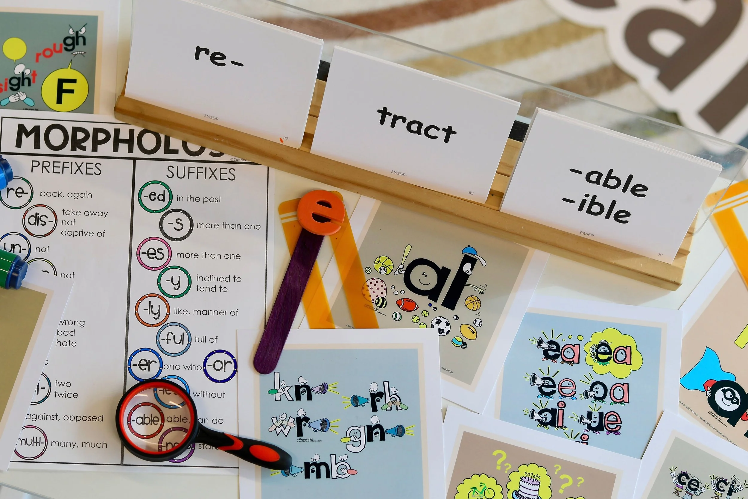 Literacy manipulative tools including flashcards, letters, and worksheets used at The Learning Loop
