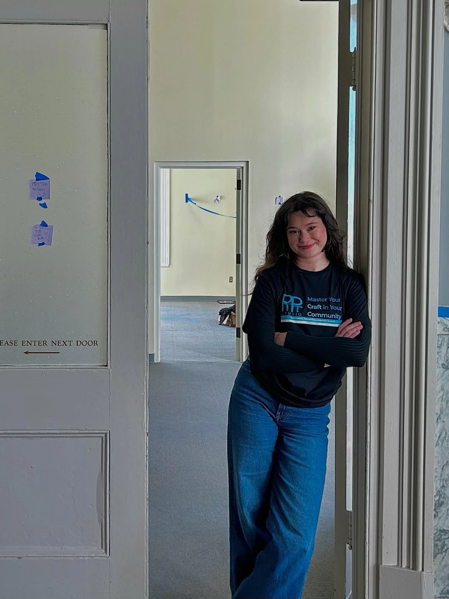 CEO Emilia Torello standing at the doors of our very first home in Historic Thalian Hall.