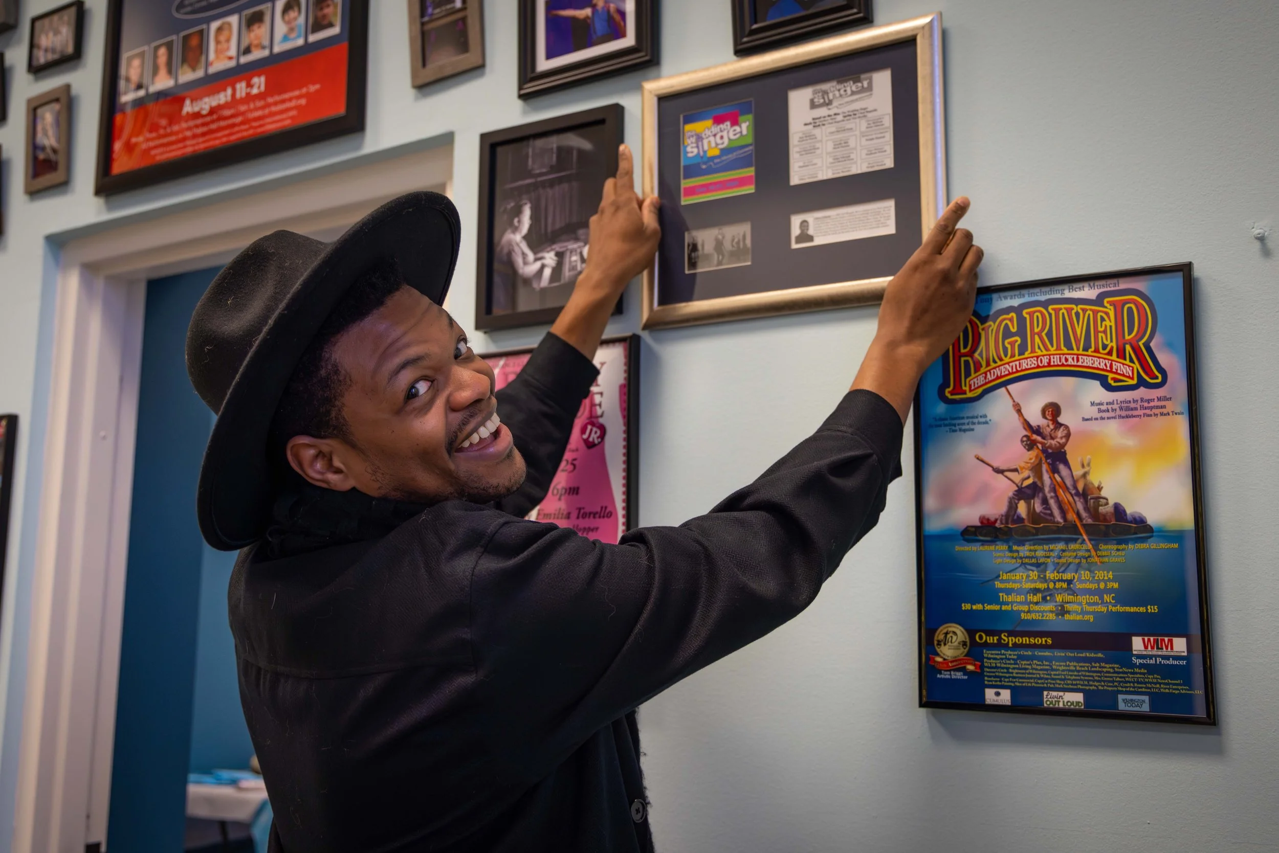Head of Musical Theatre Jaymes Osborne hangs his photo on the Community Wall at the PTPT Studio Open House on December 17, 2025.

Photographer: Riley Moore