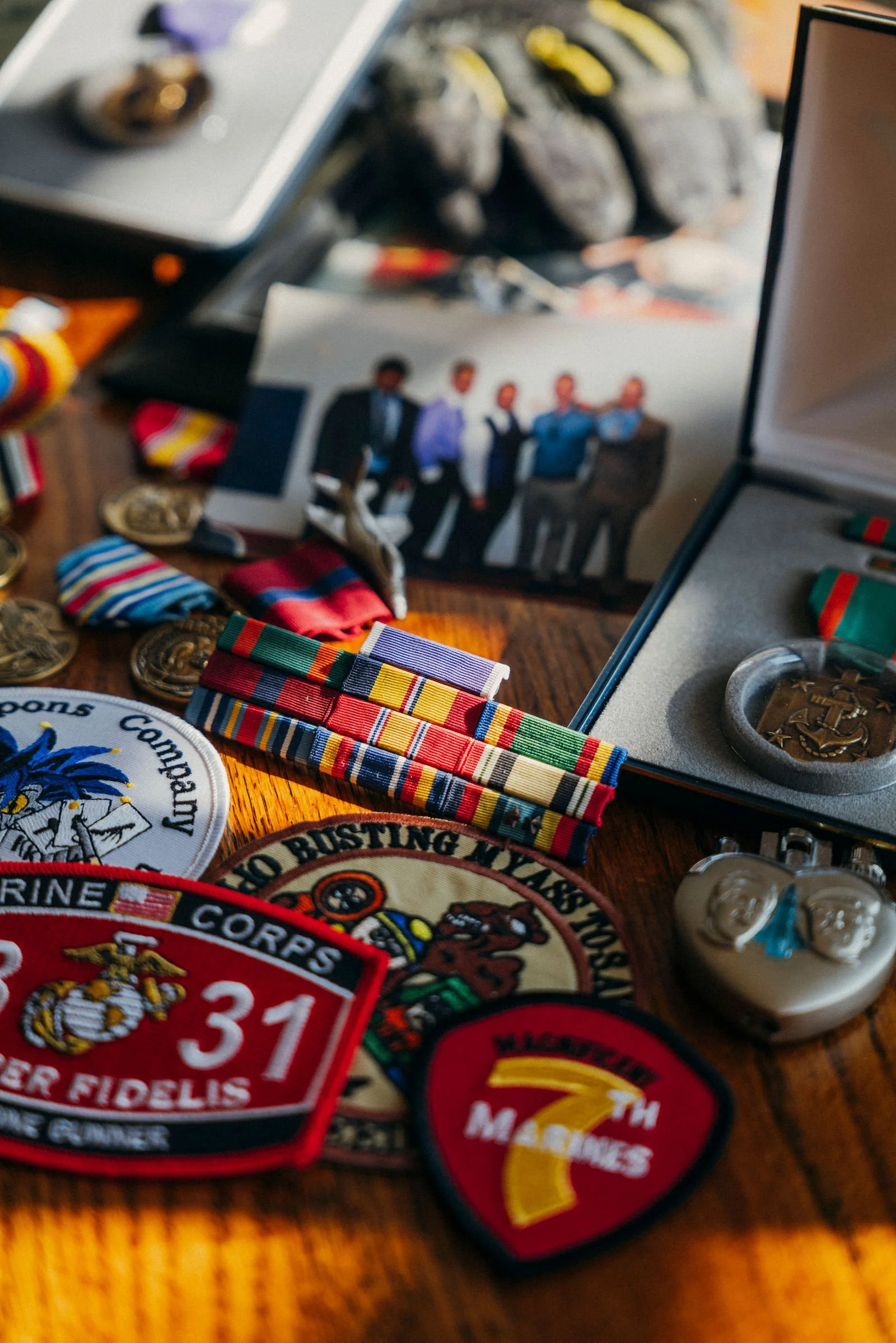 Military patches, medals and photos laid out on a table