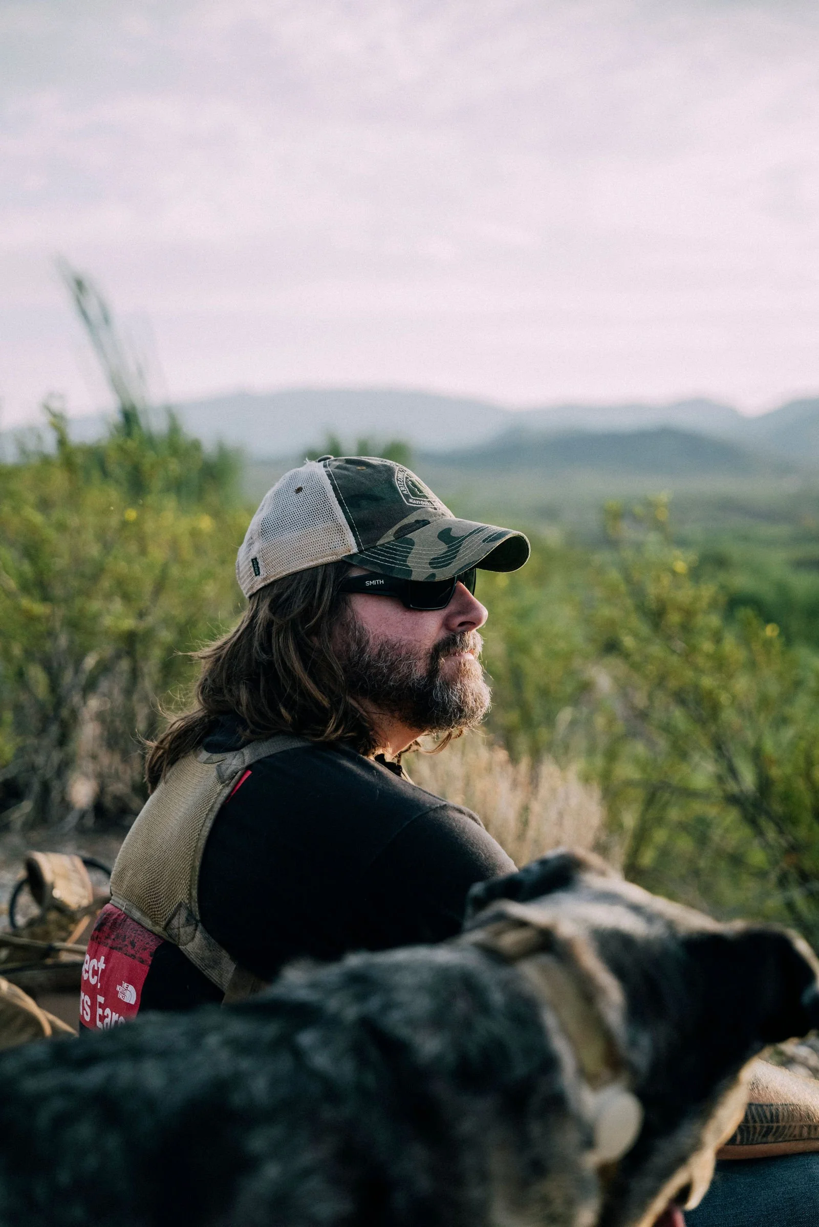 Chappy in a trucker cap looking out over the desert
