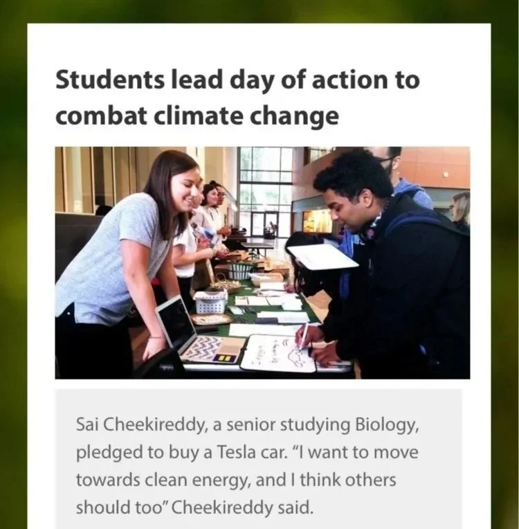 Students at a booth discussing climate change actions, with a senior biology student pledging to buy a Tesla car in a classroom or event space.