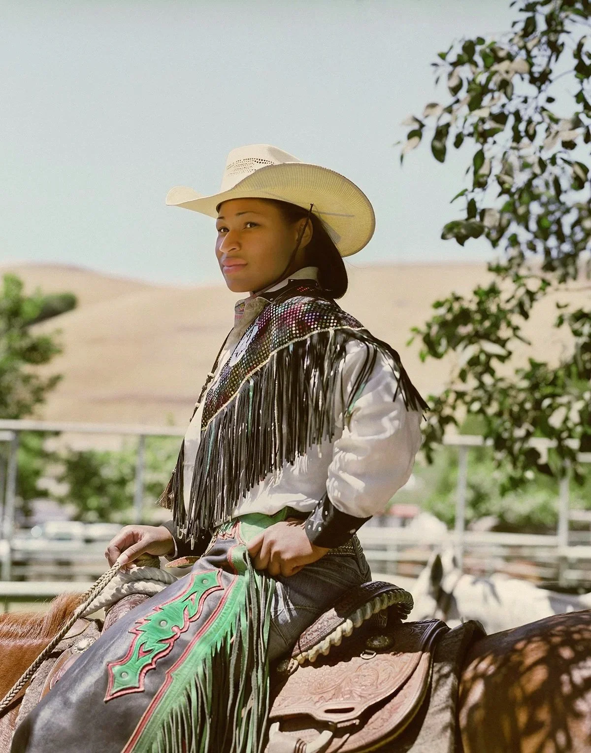 Black cowgirl seated on horseback in western attire from The New Black West, photographed by San Francisco–based commercial and editorial photographer Gabriela Hasbun.