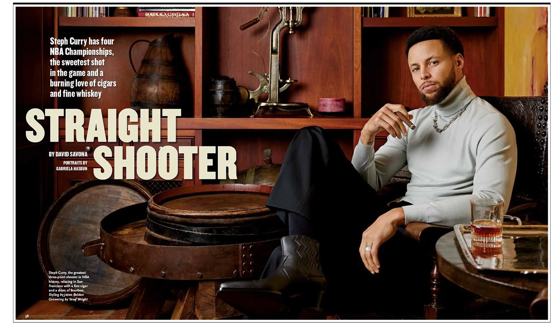 A man sitting in a leather chair holding a cigar, with a glass of whiskey on a tray beside him. The background features wooden shelves with decorative items, including a brass faucet, a wooden pitcher, and books. The image appears to be an indoor setting with warm lighting.