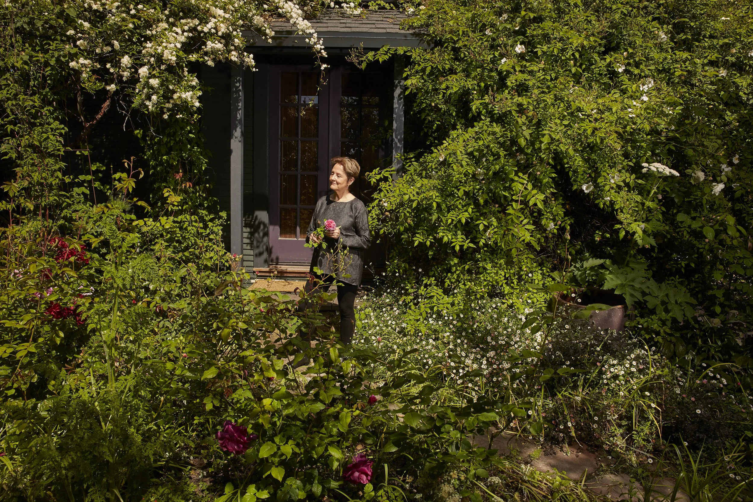 Chef Alice Waters in her Berkeley home’s English garden, photographed by Gabriela Hasbun.