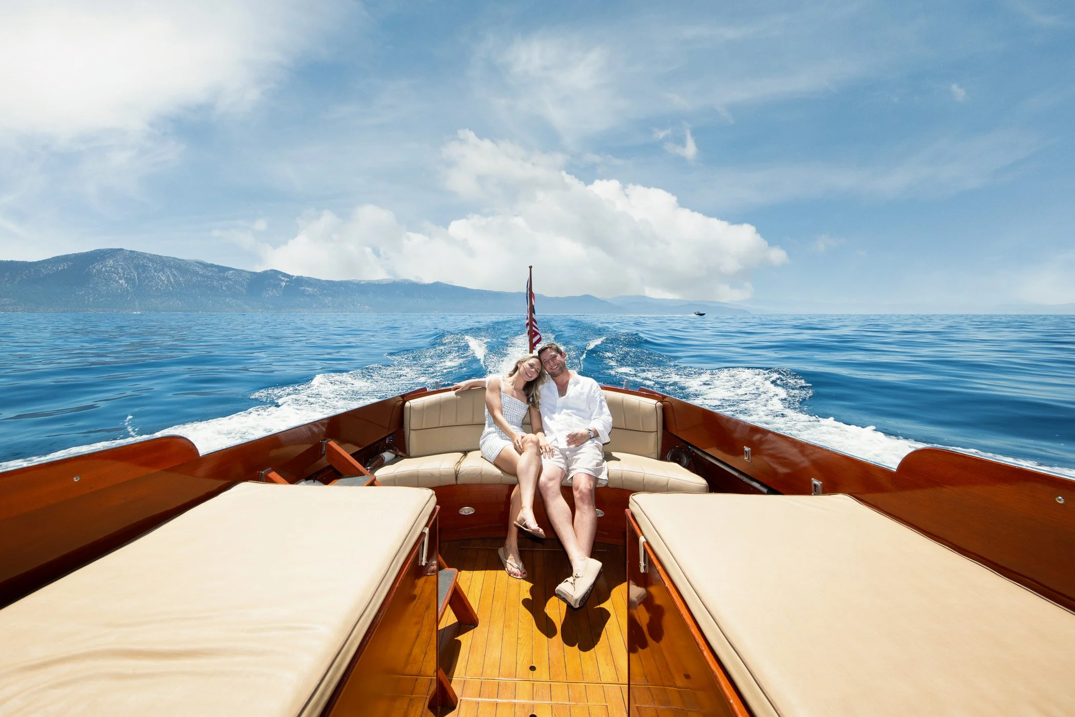 Couple on a boat at Lake Tahoe after a surprise proposal, romantic on-the-water engagement photography