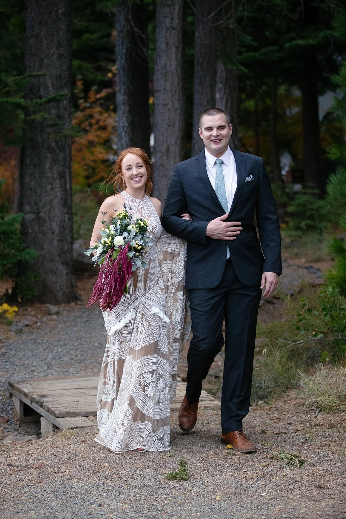 bride and groom walking by woods tahoe.jpg